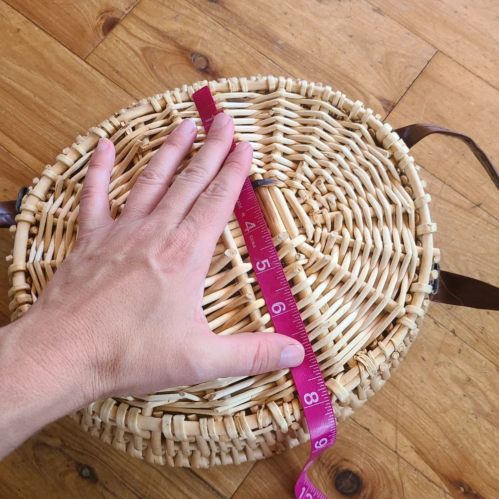 Woven wicker basket with faux leather handles